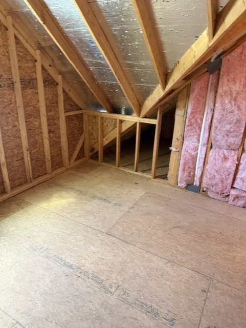 Attic after cleanout with cleared storage area
