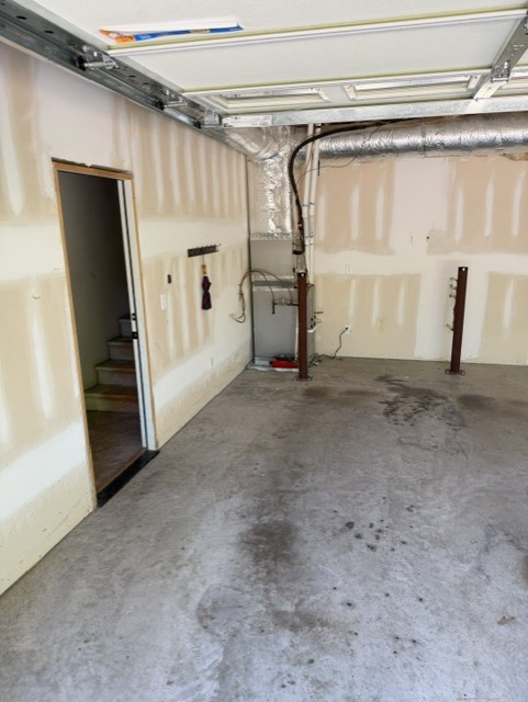 Garage after cleanout with door and wall space cleared